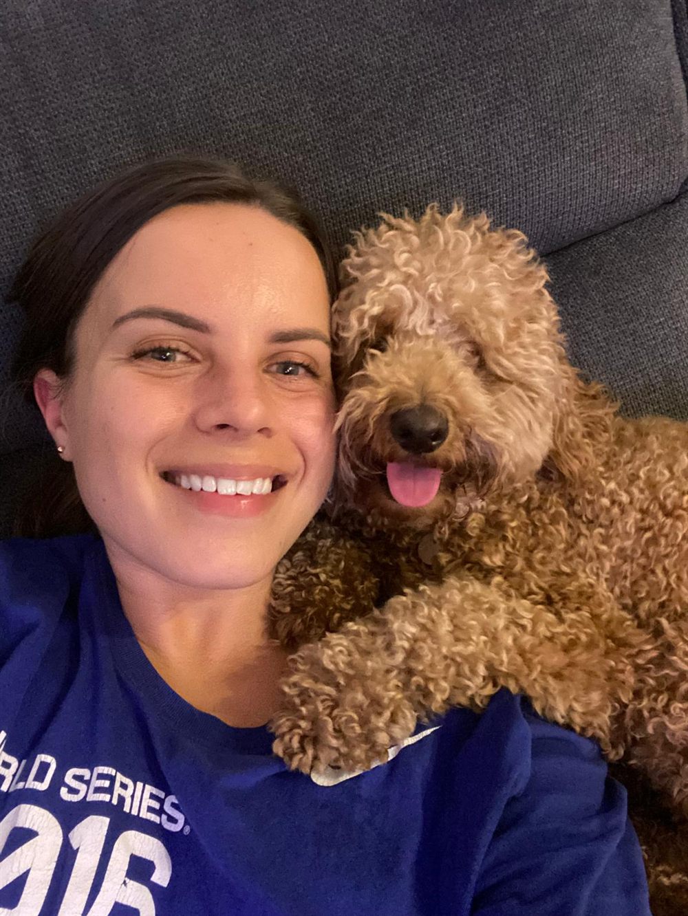 Jess smiling in a selfie with her spoodle Lucille